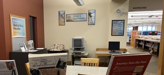 Photo of the Family and Local History area, looking from the bookshelves to the computer