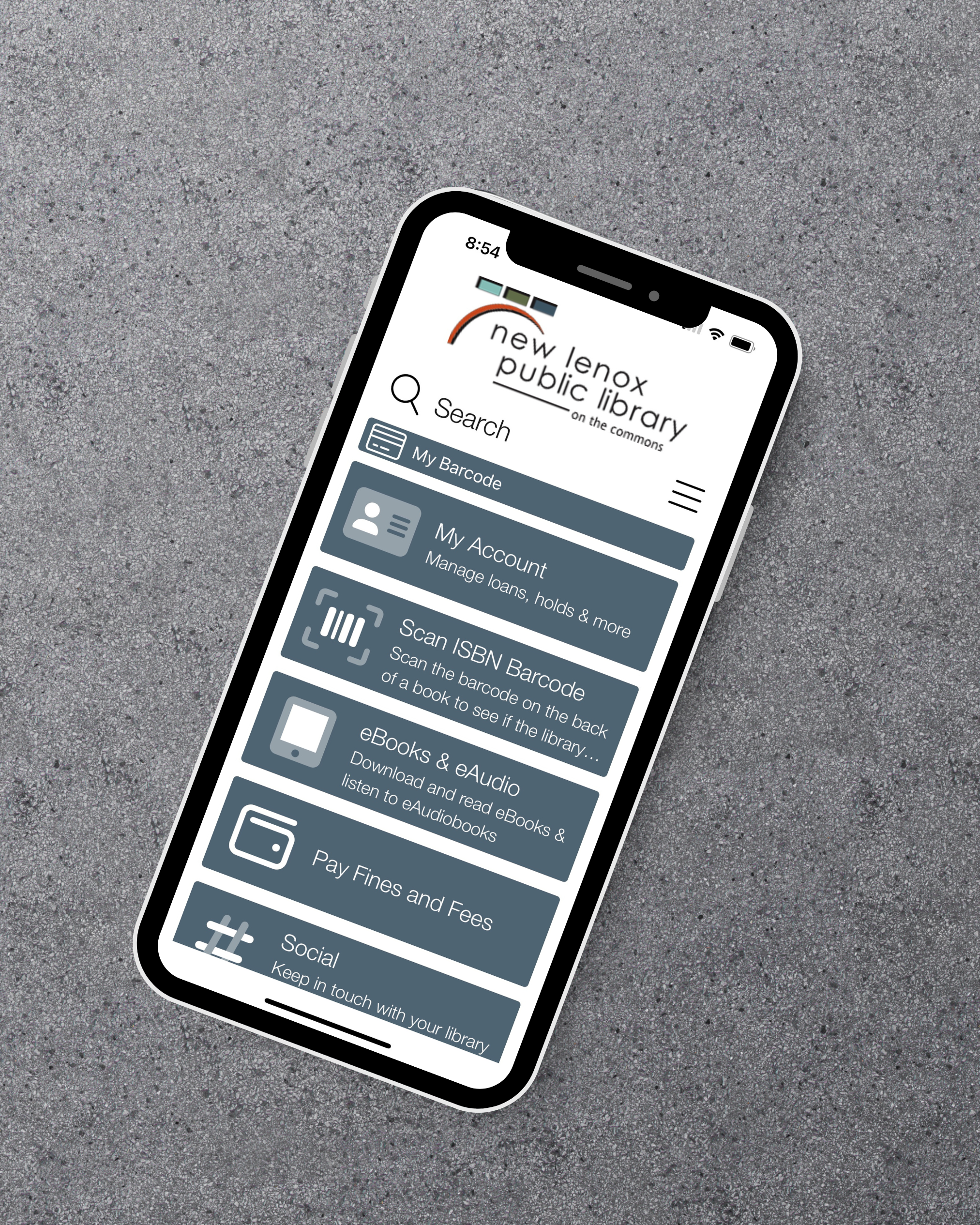 Smartphone with the Prairiecat Libraries Mobile app homescreen open, depicting the New Lenox Library logo, search bar, library card barcode, my account, and more 