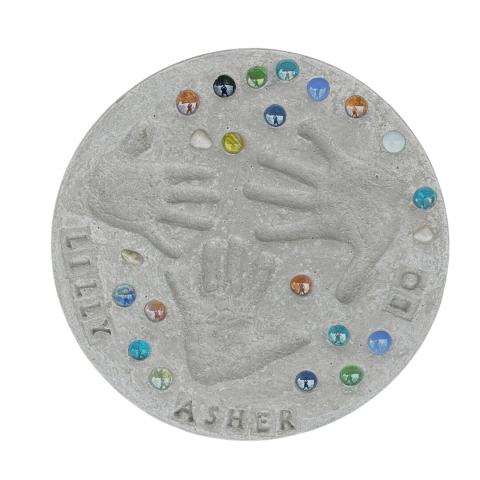 Image of a grey stone with hand prints, gem stones, and the names "Lilly" and "Asher".