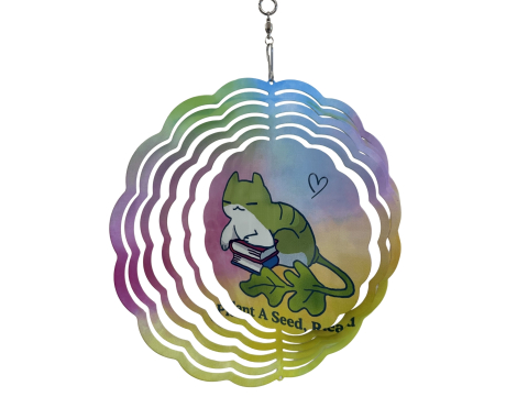 An image of a rainbow wind spinner with a cat in the middle and the words "Plant a Seed, Read"
